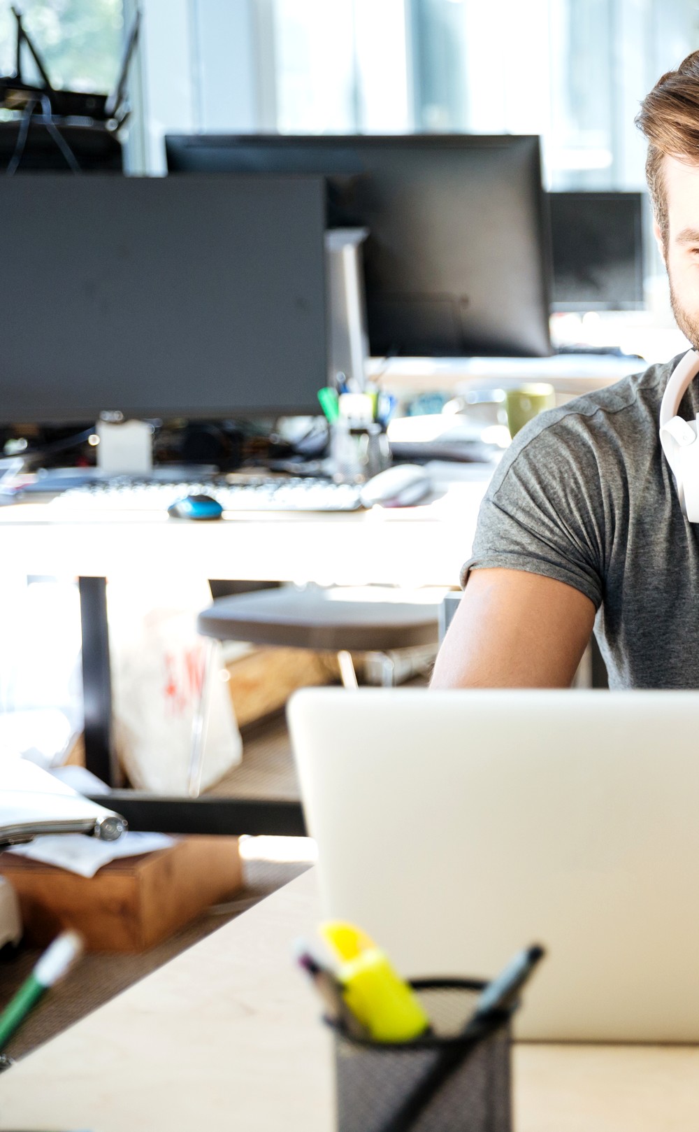 Smiling young colleagues sitting in office coworking